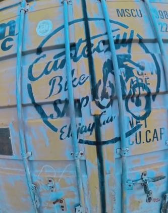 Blue shipping container with graffiti markings